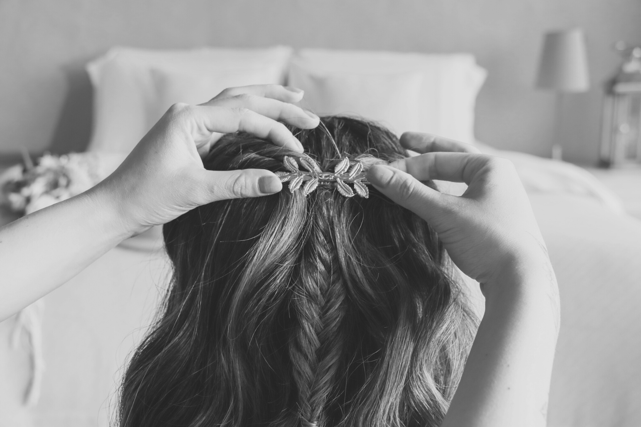 Hairstylist Putting Bridal Accessory on Bride's Hair